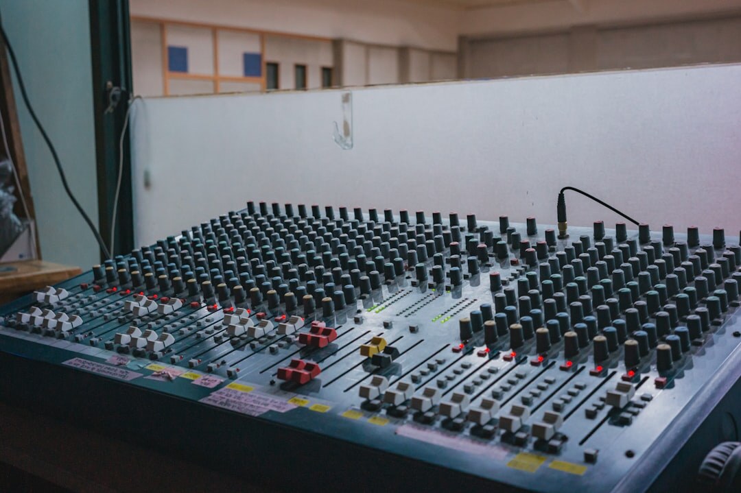 Professional recording studio desk with mixing console and equipment